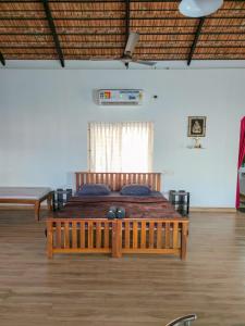 a bedroom with a wooden bed in a room at Benny's Abode by UrbanEase Properties in Mangalore +37 photos