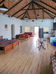 a large living room with wooden floors and a couch at Benny's Abode by UrbanEase Properties in Mangalore