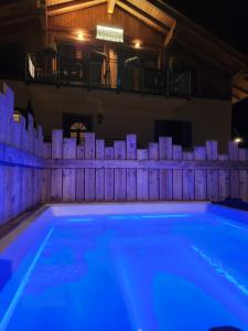 a swimming pool with blue lighting in a house at Aparthotel Dolomites Living&Relax in Commezzadura