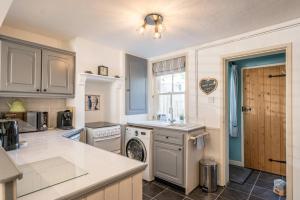 a kitchen with a sink and a dishwasher at Fishermans Cottage, Aldeburgh in Aldeburgh