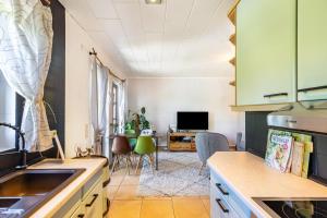 a kitchen with green cabinets and a dining room at Cottage in Schlangenbad in Schlangenbad