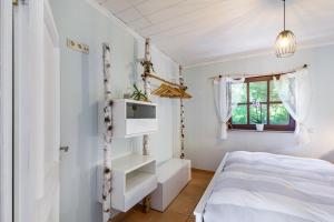 a bedroom with a bed and a window at Cottage in Schlangenbad in Schlangenbad +19 photos
