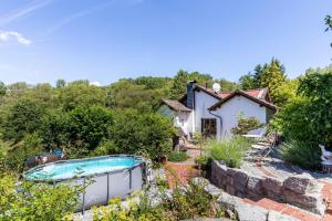 a house with a swimming pool in a garden at Cottage in Schlangenbad in Schlangenbad