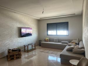 a living room with a couch and a table at Florida Waves in El Jadida