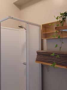 a shower in a bathroom with a glass door at Det Gamla Postkontoret in Råda