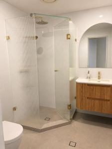 a bathroom with a shower and a toilet and a sink at Sundown terrace in North Fremantle