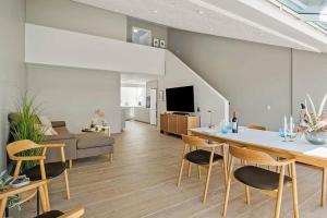 a living room with a table and chairs and a couch at BL1001-Blokhus-Ferren-95 in Blokhus