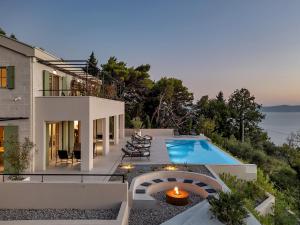 a villa with a swimming pool and a house at Villa Laurante in Tučepi