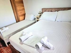 a hotel room with two beds with towels on them at Villa Rexho in Berat