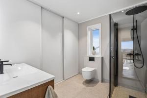 a bathroom with a toilet and a sink and a shower at Apartment Lofoten, Leknes in Leknes +31 photos