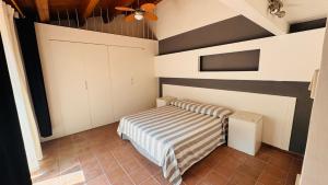 a bedroom with a bed and a tv in it at Villa Bruno in Modica +23 photos