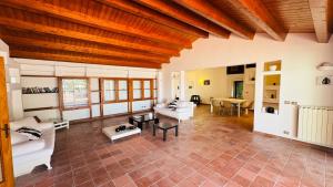 a living room with white furniture and a wooden ceiling at Villa Bruno in Modica