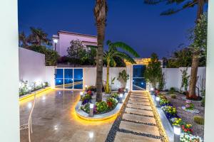 a courtyard with flowers and a palm tree at Villa 33 Ultra Lux High-End in Tangier