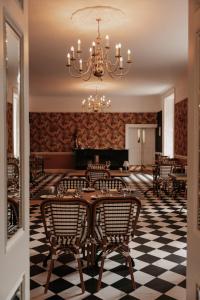 a dining room with chairs and a chandelier at Summerhill House Hotel in Enniskerry +41 photos