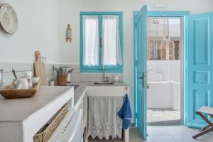 a kitchen with a sink and a blue cabinet at Sokaki Patmos in Skala +40 photos