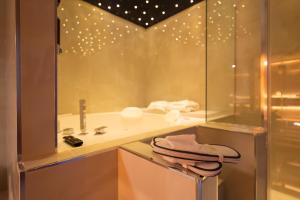 a bathroom with a sink and a shower with a mirror at 3 torri GATEWAY in Maddaloni