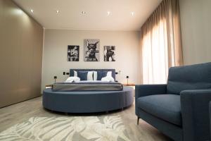a bedroom with a bed and a couch and a chair at 3 torri GATEWAY in Maddaloni