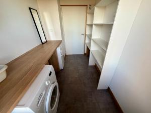 a laundry room with a washer and dryer in it at Gîte de groupe et charmant cottage L'Agnel in Domaize