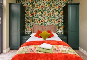 a bedroom with a large bed with a floral wallpaper at Boutique Stays at 78 in Bangor