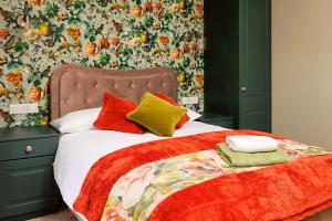 a bed with colorful blankets and pillows on it at Boutique Stays at 78 in Bangor +62 photos