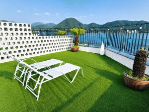 a patio with a white lounge chair on the grass at Raum Resort 1 in Suncheon