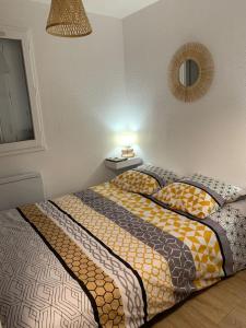a bedroom with a bed with pillows and a lamp at Apartment with pool and beach access 2 No 31 in Quiberon +17 photos