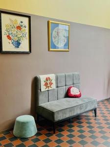 a gray couch with two pillows on a room at Hótel Bifröst in Bifrost