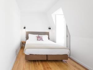 a bedroom with a large bed with a mirror at LSA Castelo S Jorge by Numa in Lisbon