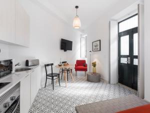 a kitchen with a red chair and a table at LSA Castelo S Jorge by Numa in Lisbon +45 photos