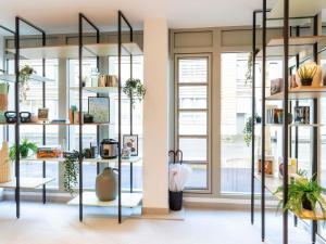 a room with shelves of plants and windows at Adagio Access Paris Nanterre in Nanterre