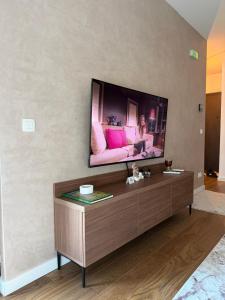 a living room with a television on a wall at Harbour Light Residence in Bjeliši