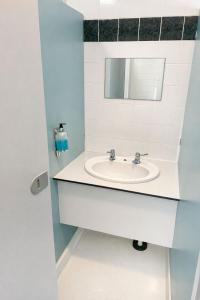 a bathroom with a sink and a mirror at Glamping Cabins in the Heart of Snowdonia in Dolgellau