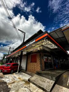 a building with a car parked in front of it at Hotel Caeté in Bragança