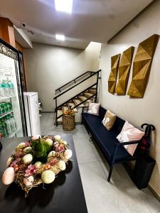 a living room with a couch and a table with vegetables at Hotel Caeté in Bragança