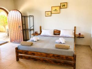 a bedroom with a large bed with two pillows on it at Villa Maria Christina with Private Pool in Crete in Skoúrvoula