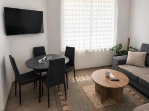 a living room with a table and a couch at Sofija 1 in Jesenice