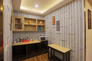 a kitchen with a counter and a microwave on a wall at Hotel Galaxy international Delhi igi Airport Free pickup in Ghaziabad +44 photos
