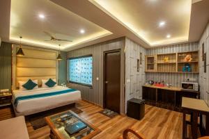 a bedroom with a bed and a table in a room at Hotel Galaxy international Delhi igi Airport Free pickup in Ghaziabad