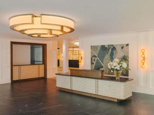 a lobby with a reception desk and a vase of flowers at Fairmont Cheshire The Mere in Knutsford +89 photos
