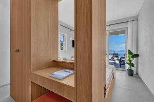 a bedroom with a bed and a desk with a book at Villa Laurante in Tučepi +37 photos