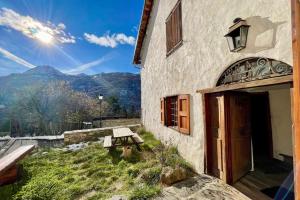 a building with a wooden door and a bench outside at 130 sqm Apartment in a Village House in La Salle-les-Alpes
