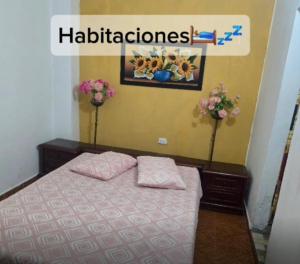 a bedroom with a bed with two pillows on it at Casa de Descanso la Cascada in Sopetrán