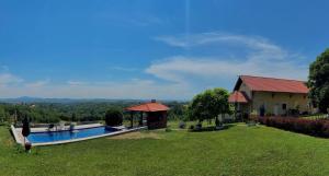 a house with a swimming pool in a yard at Kosmaj-Suncani Breg in Drlupa