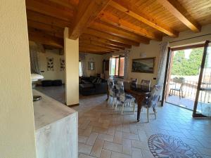 a kitchen and living room with a table and chairs at Hotel Adria & Resort in Toscolano Maderno