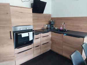 a kitchen with a stove and a sink at In den Bergen in Übersaxen