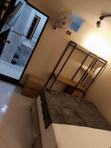 a room with a table and a ceiling fan at Hotel Golden 70 in Medellín