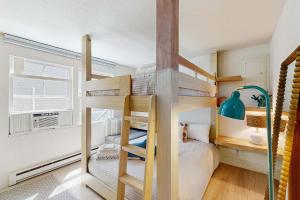 a bedroom with a bunk bed with a ladder at Moon Tide - Bayside Beach Access & Parking in Provincetown