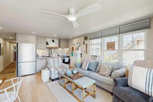 a living room with a couch and a ceiling fan at Moon Tide - Bayside Beach Access & Parking in Provincetown