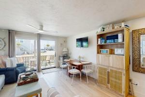 a living room with a table and a dining room at Moon Tide - Bayside Beach Access & Parking in Provincetown