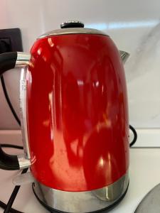 a red tea pot sitting on top of a stove at Studio Natalie in Marina di Massa